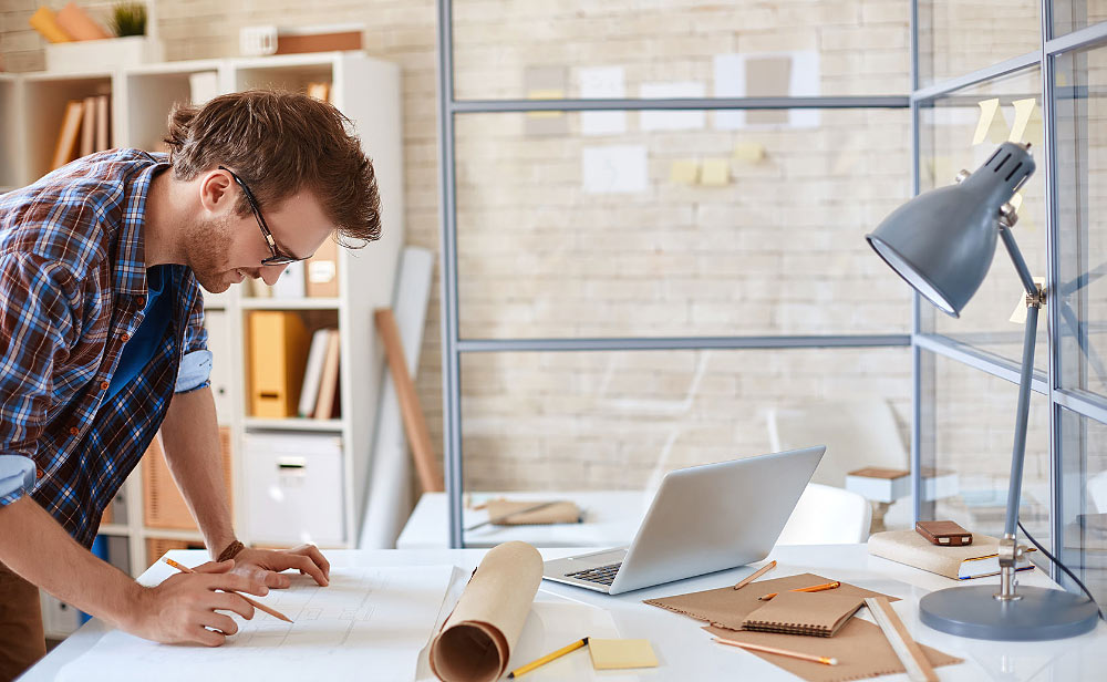 Person Working on Construction Plans Person Working on Construction Plans